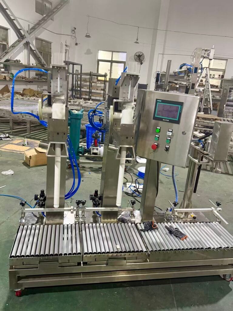 Twin-head industrial liquid filling machine with raised filling nozzles in workshop